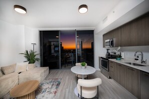 Eine moderne Wohnung mit Balkon, Essbereich und Küche.