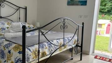 Family Quadruple Room, Garden View | Individually furnished, desk, laptop workspace, blackout drapes