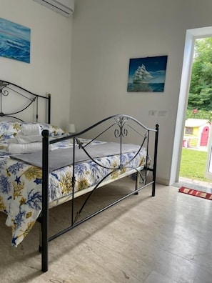 Family Quadruple Room, Garden View | Individually furnished, desk, laptop workspace, blackout drapes