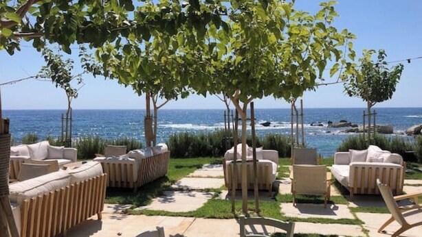 An outdoor seating area with sofas and chairs, a pathway, and trees. - Villa Marina Sea-Views with Private Pool (Peyia)