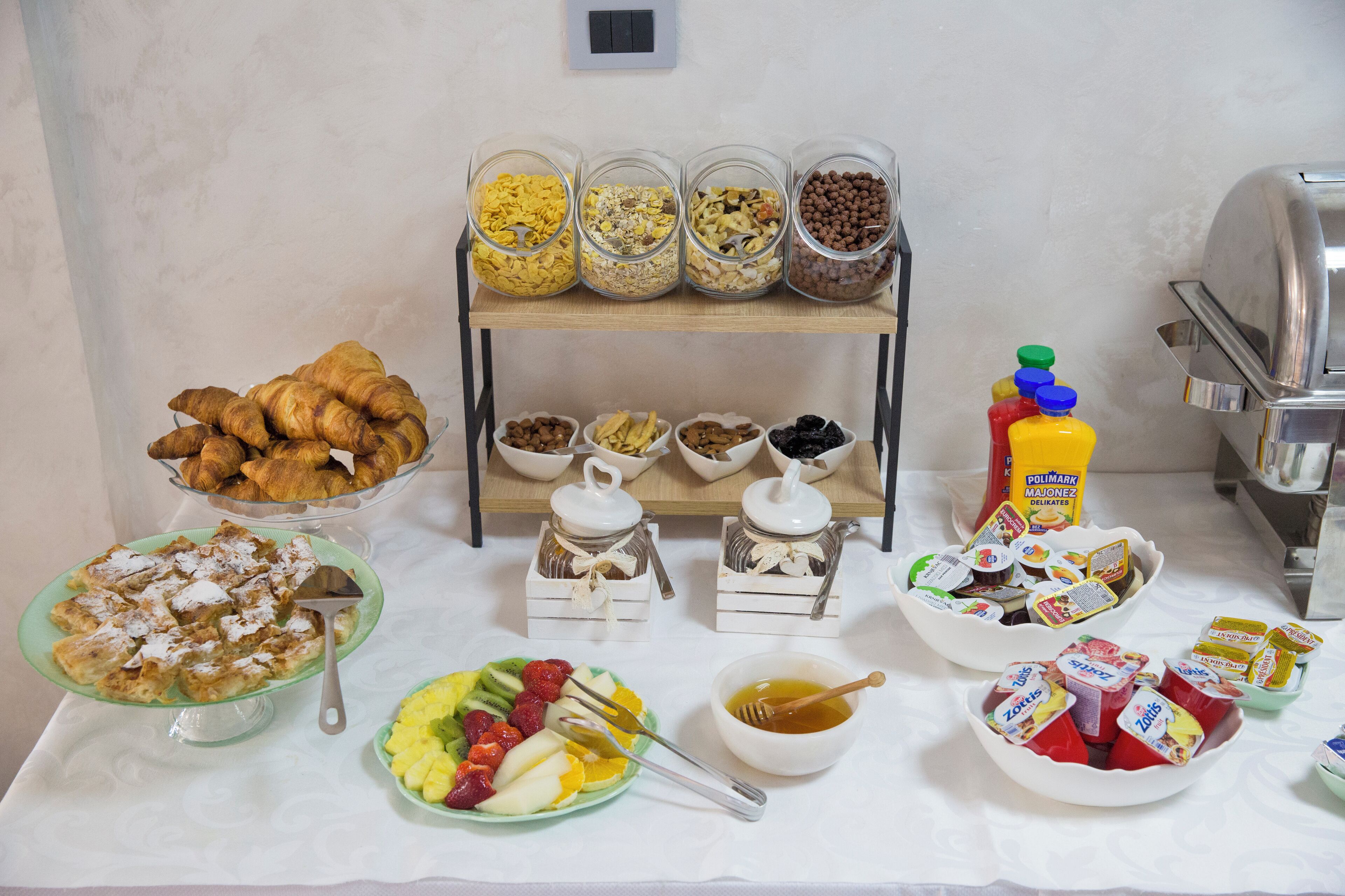 A breakfast buffet with various food items and condiments.