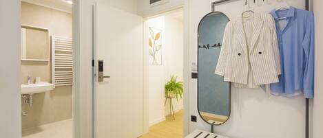 A modern bathroom with a sink, towel rack, and a mirror.