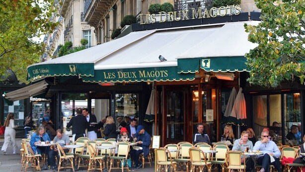 An outdoor cafe with outdoor seating and a covered awning. - PARISIAN ELEGANCEWITH EXPOSED BEAMS PERFECTLY LOCATED-SAINT GERMAIN– RUE DU BUCI (Paris)