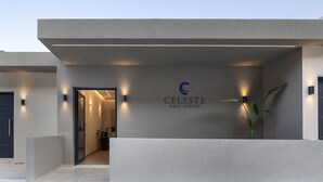 En moderne bygning med facade og skilt med 'CELESTE BALI SUITES'.