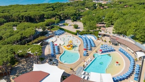 A resort with multiple swimming pools, a water park, and a beach area with umbrellas. - Charme Plus by Interhome (Castiglione della Pescaia)