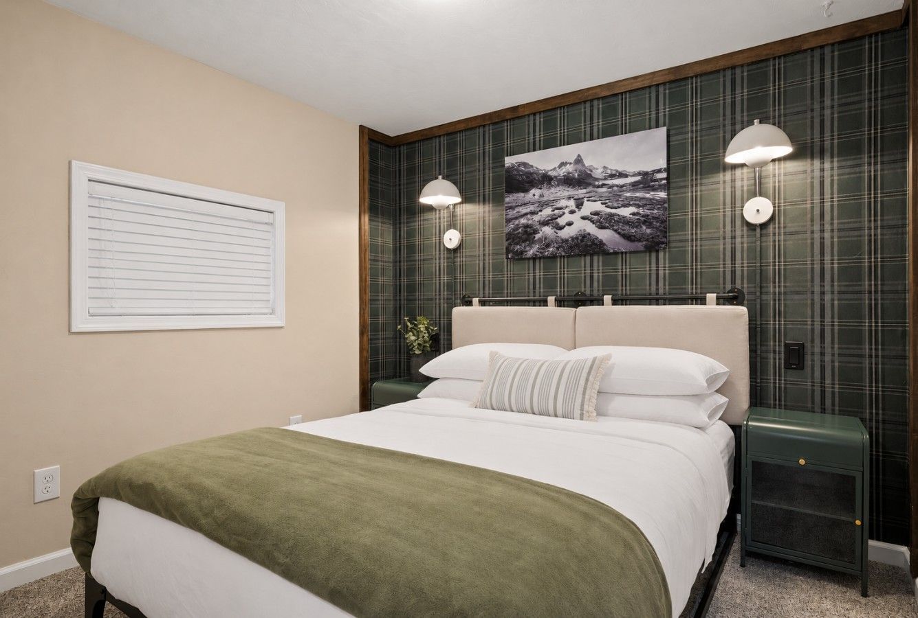 Retreat to plush bedding and cozy lodge-inspired comfort after a day of mountain adventures.