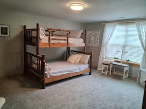 A bunk bed room with a small table and a window with curtains. - NEW! Sleeps 5 on Lake Kathy, close to I 75 interstate, Rest, Relax, Fish, Repeat (Tunnel Hill)