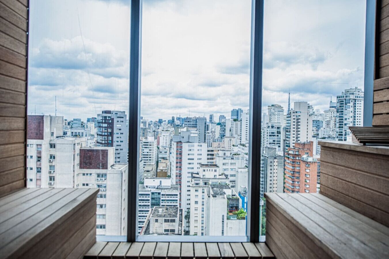 A high-rise building with a view of a cityscape through large windows.