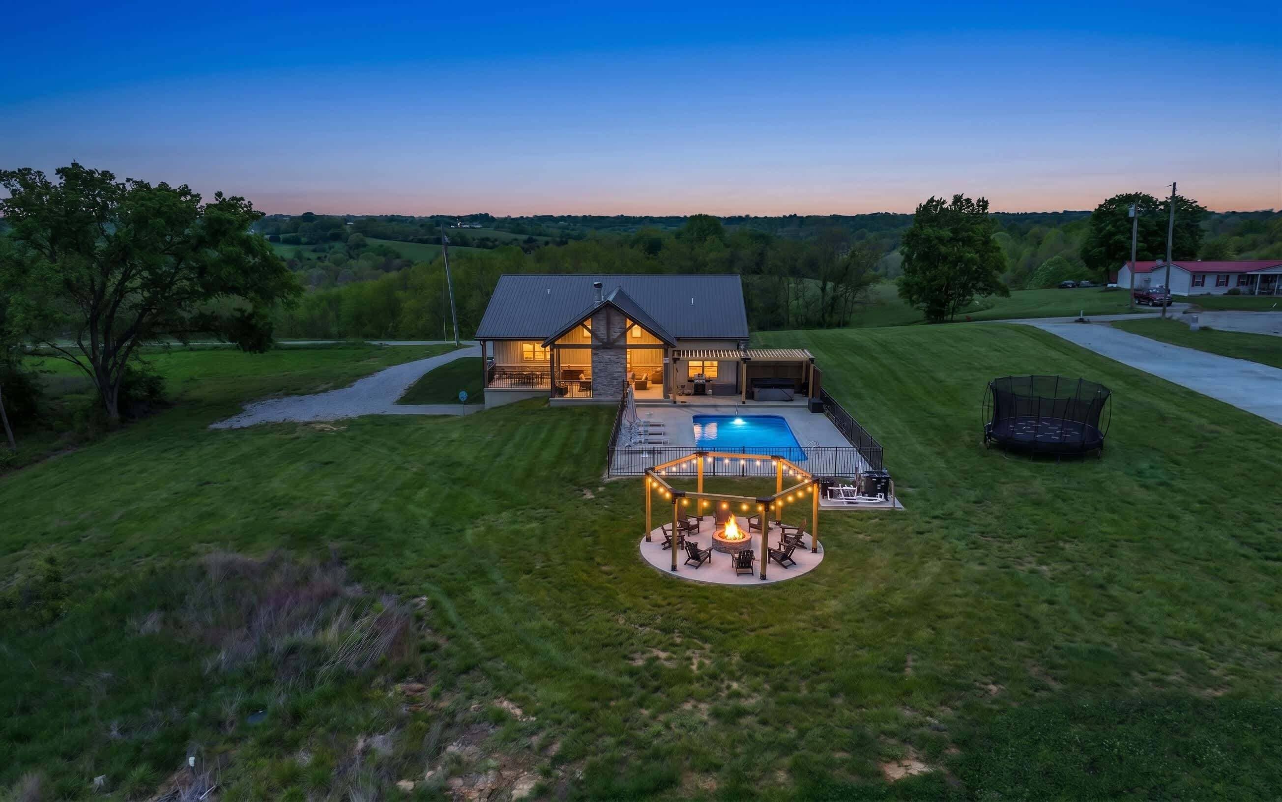 A two-story house with a large deck and a swimming pool.