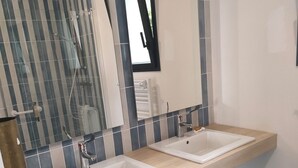 A modern bathroom with two sinks, a large mirror, and a shower enclosure. - Ground floor room with unlimited access to outdoor spa (Porcaro)