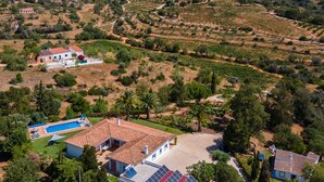 A large property with multiple buildings, a swimming pool, and extensive gardens.