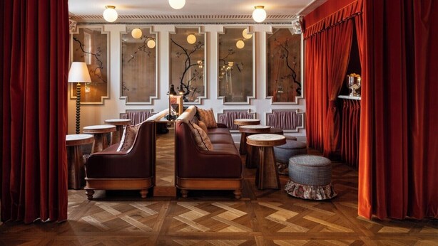 A luxurious interior with a herringbone floor, elegant furniture, and decorative mirrors. - The Hotel Lili - Beverly Hills (Beverly Hills)