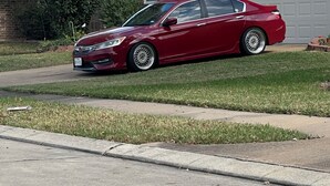 A red sedan parked on a residential street. - Cozy 1-bedroom house with AC in quaint Houston neighborhood (Houston)
