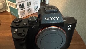 A Sony camera with a lens, a viewfinder, and a control dial. - Cozy 1-bedroom house with AC in quaint Houston neighborhood (Houston)