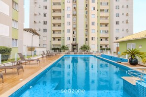 A swimming pool with lounge chairs and a building in the background. - Apt w/ BBQ & Balcony, 400m From the Beach Leaa0506 (Picarras)