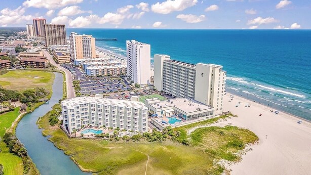 A coastal hotel with multiple buildings, a beach, and a river. - 🌟Oceanfront~Awesome Amenities~ Sands Beach Club 722🌟 (Myrtle Beach)