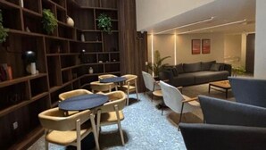 A modern interior with a central seating area, wooden shelving, and a skylight. - Cozy apartment in a modern building in the heart of Rio, accommodates up to 6 people. (Rio de Janeiro)