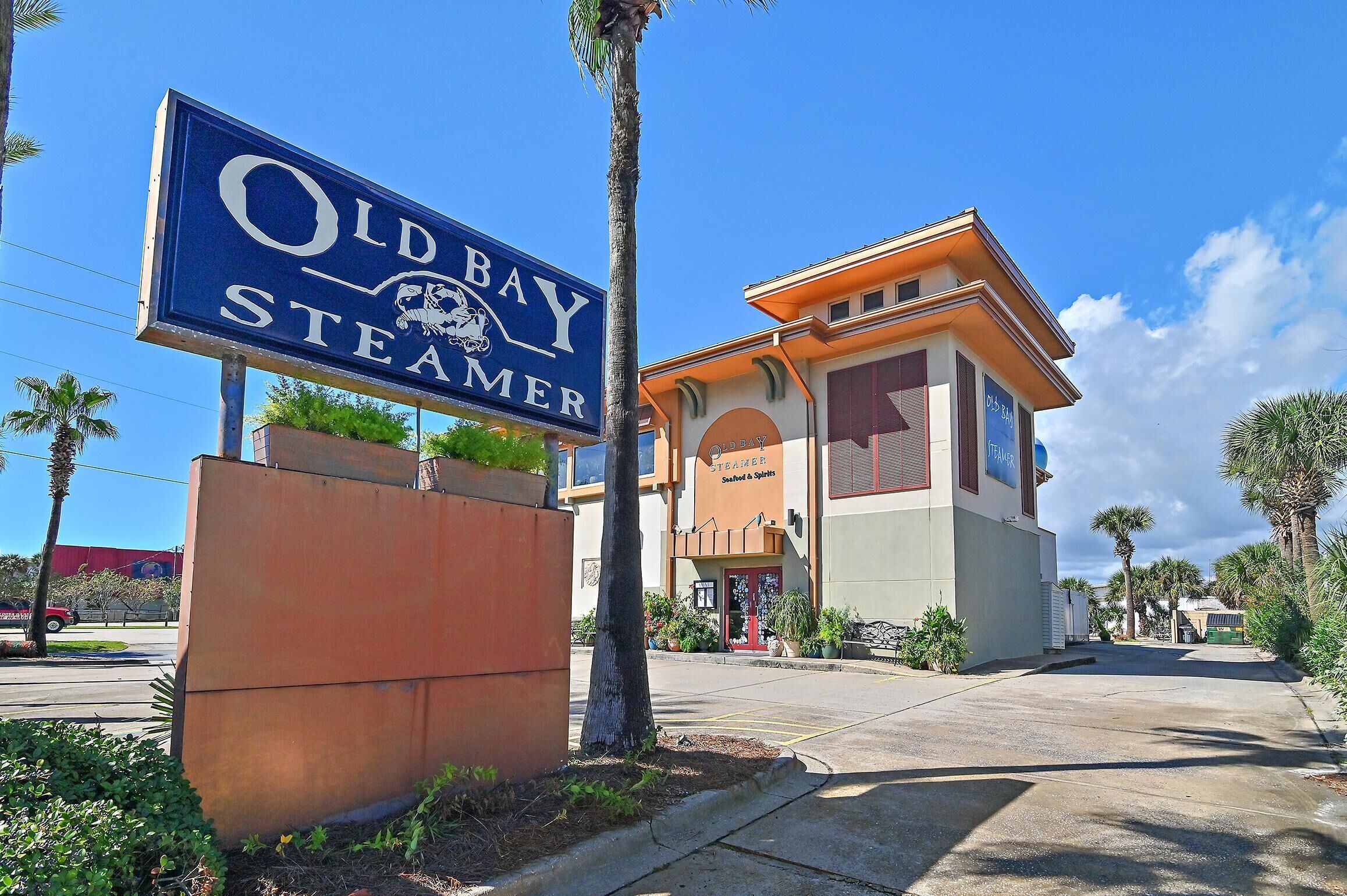 A building with a sign reading 'Old Bay Steamer' and a smaller sign for 'Steamer Seafood & Spirits.'