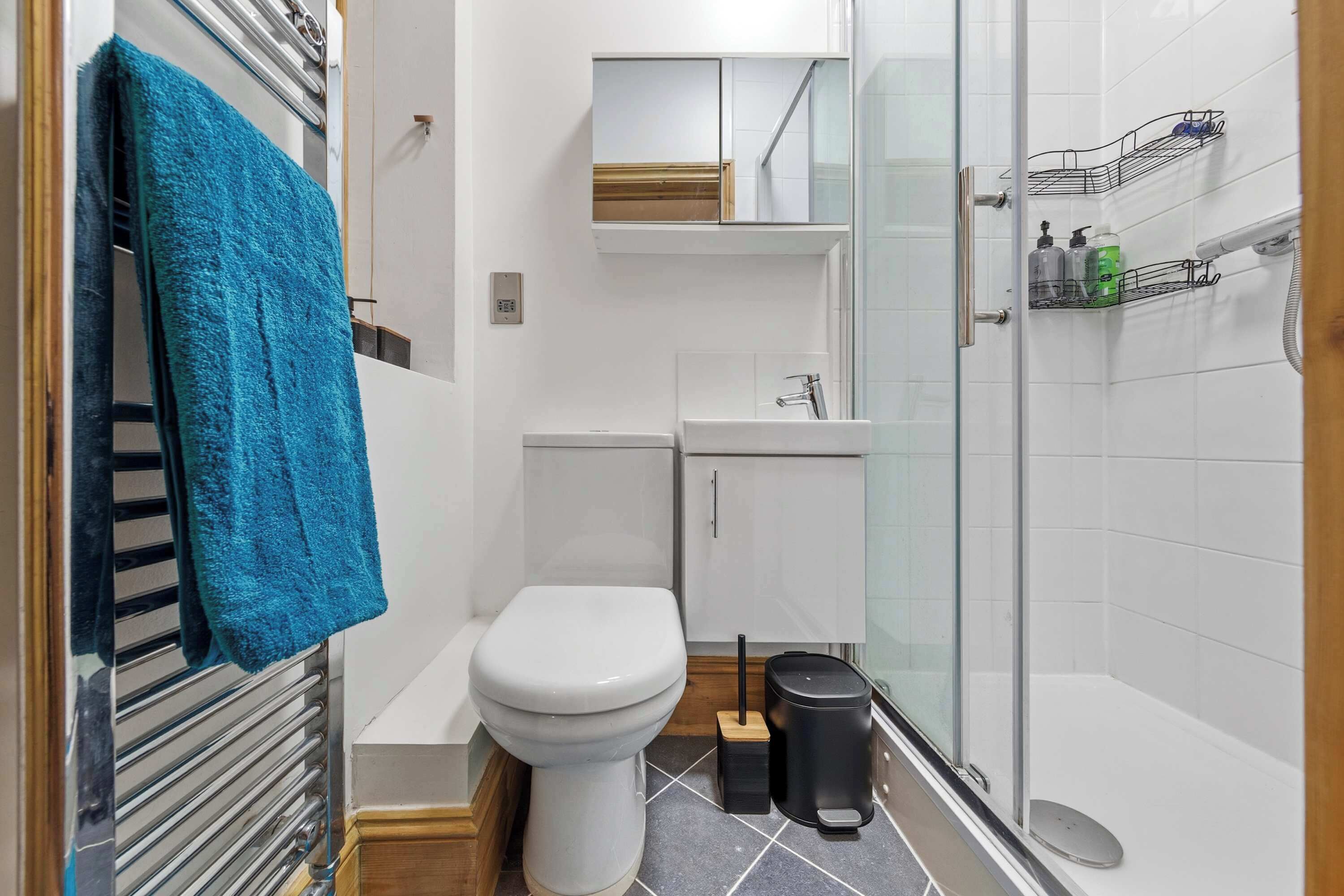 A modern bathroom with a toilet, sink, and shower area.