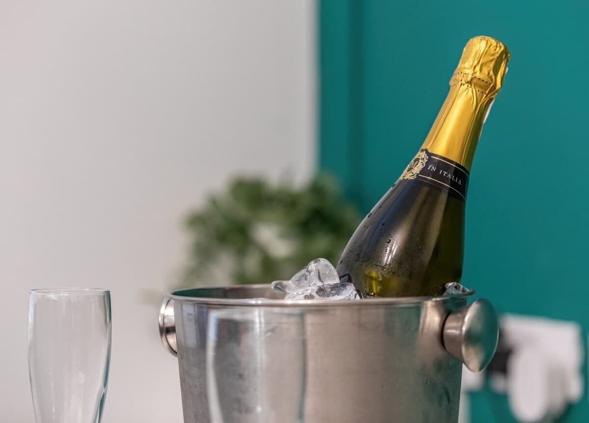 En champagneflaska i en metallhink fylld med is.
