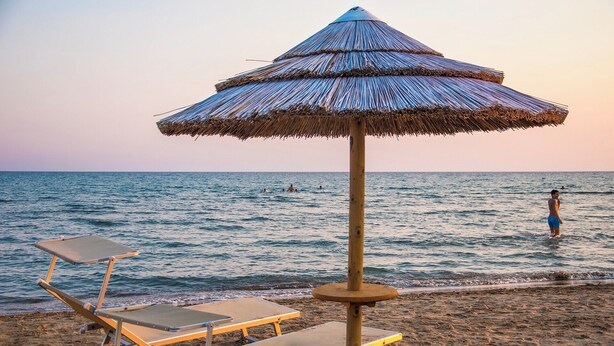 A beach with a thatched umbrella and two lounge chairs. - Lo Scarabeo - Two Bedroom Villa, Sleeps 4 (Granelli)