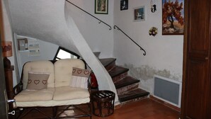 A cozy room with a sofa, a chair, a staircase, and a door. - Village house Entrechaux (Entrechaux)