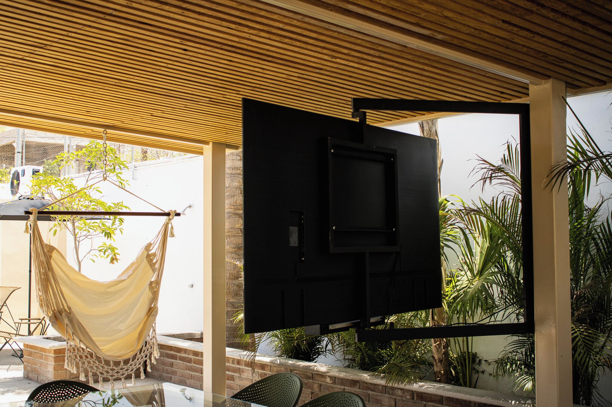 A hammock, a TV, and outdoor seating.