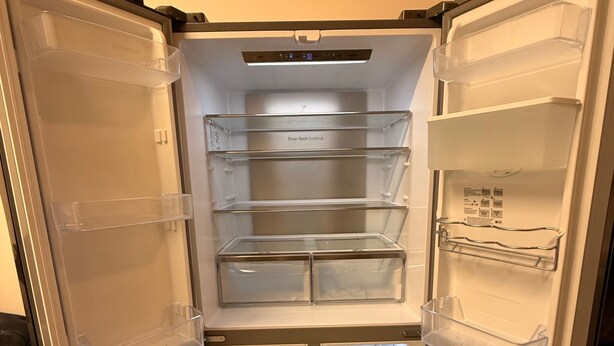 A refrigerator with multiple transparent shelves and a freezer compartment. - Stylish Dream Home With 4 En-suite Bedrooms (Liverpool)