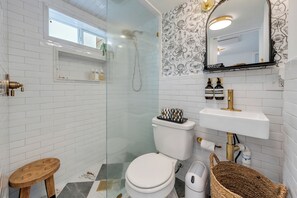 Douche, baignoire à remous, séchoir à cheveux, serviettes fournies