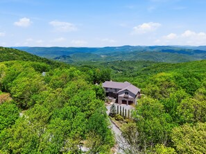A house surrounded by lush greenery and mountains. - LUX Lodge - Sauna, Chef Kitchen+ Long Range Views! (Banner Elk)