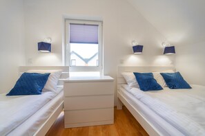 A twin room with two beds, a window, and wall-mounted lights. - Holiday Homes With Pool, Close to the Beach (Rewal)