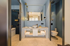A modern bathroom with a marble vanity, a large mirror, and a herringbone-patterned wall. - L'Union Han Istanbul, Vignette Collection by IHG (Istanbul)