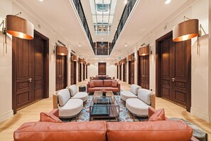A spacious lobby with a central seating area, wooden doors, and a skylight. - L'Union Han Istanbul, Vignette Collection by IHG (Istanbul)