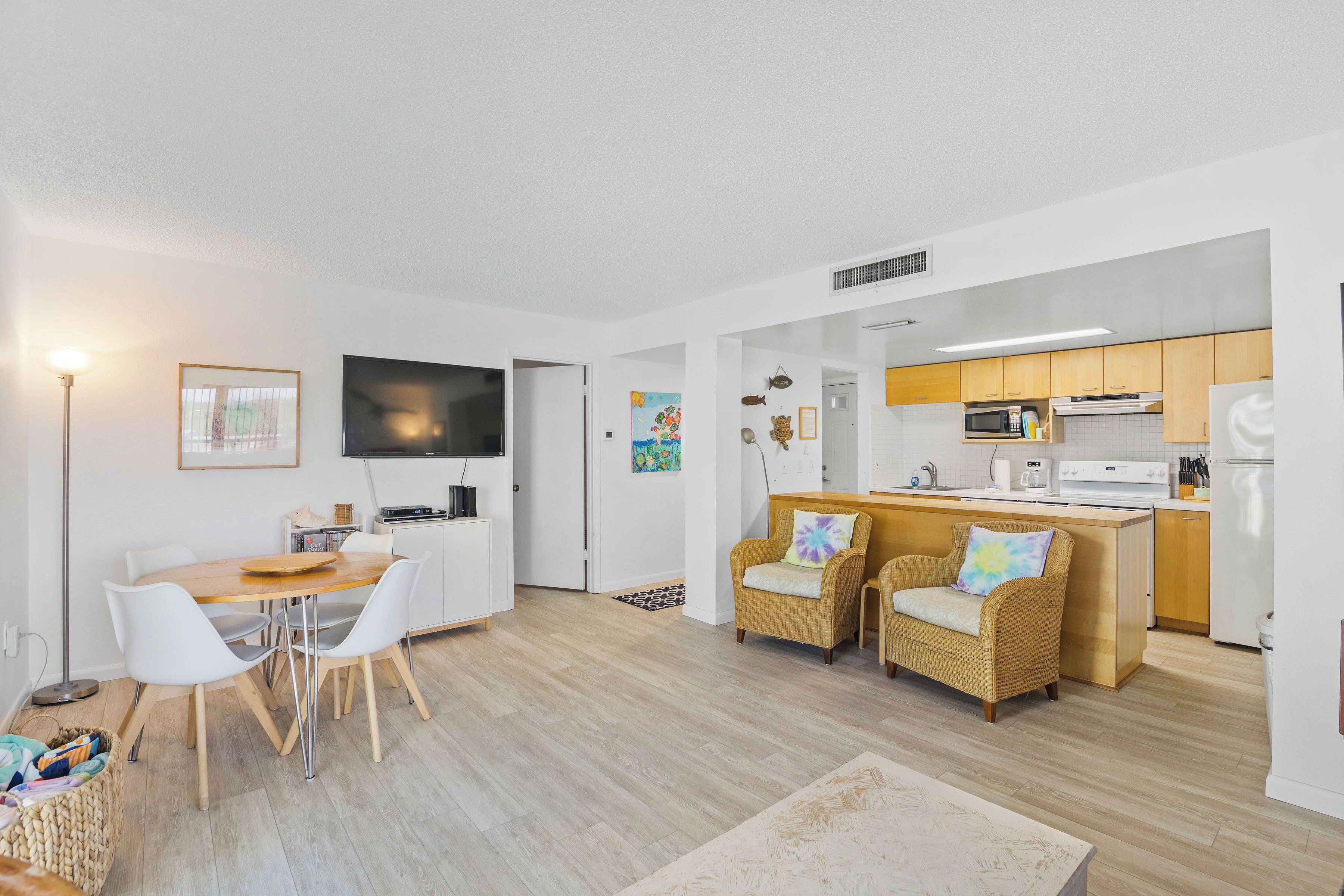 A modern, open-plan living space with a dining area, kitchen, and seating area.
