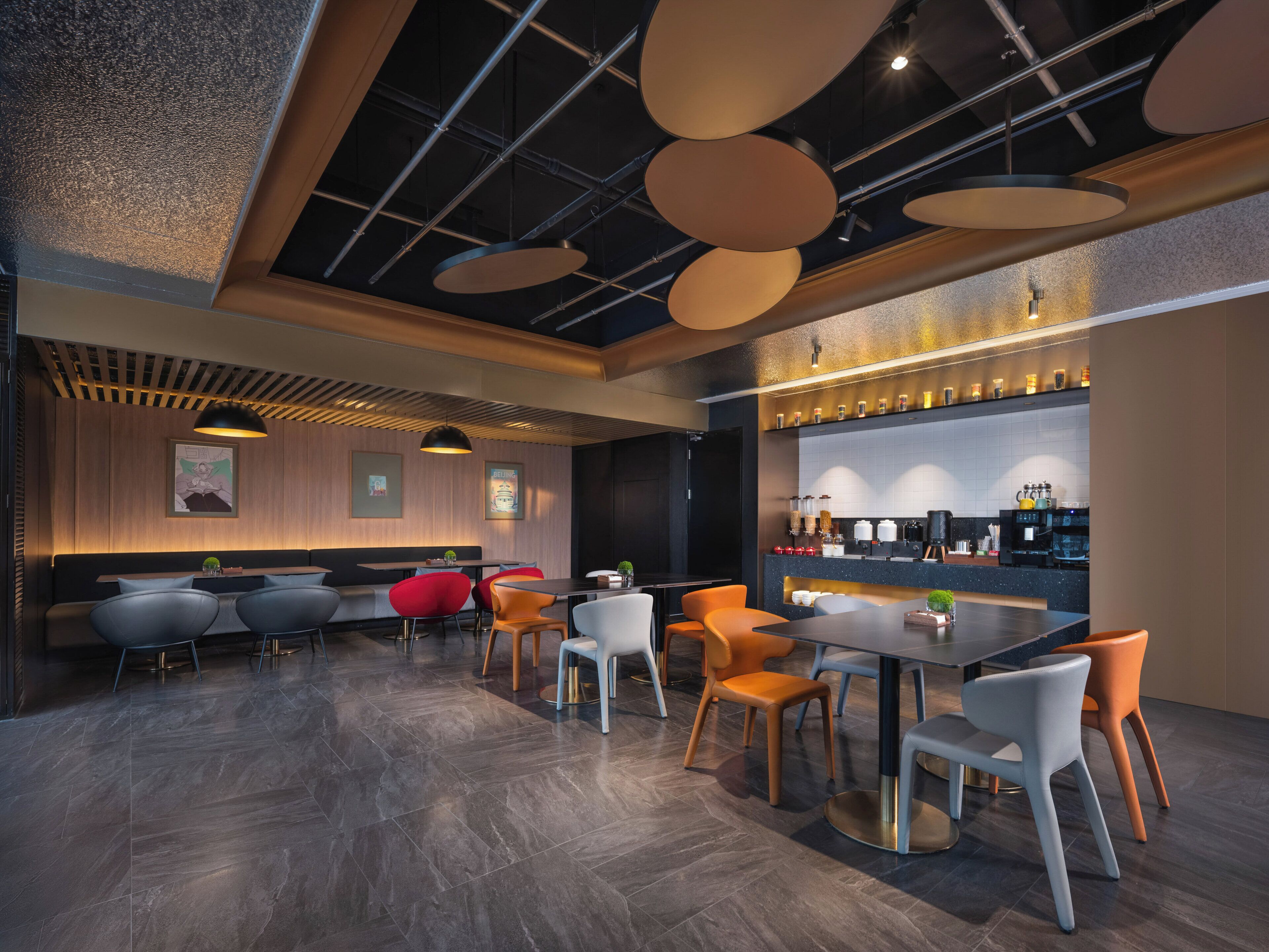 A modern restaurant with a bar area, seating arrangements, and a ceiling with exposed beams and pendant lights.