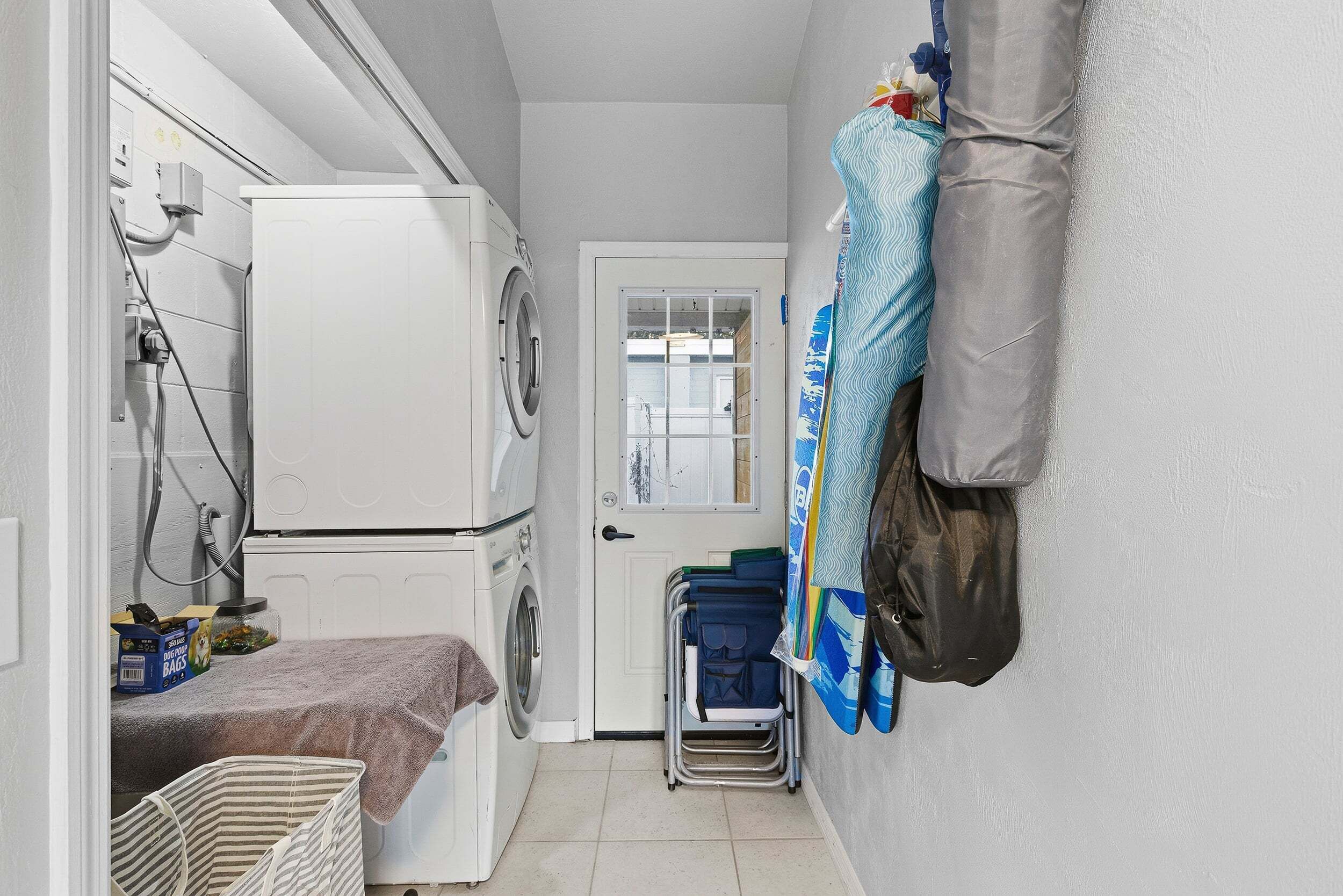 A laundry room with a washing machine, a dryer, and a folding station.