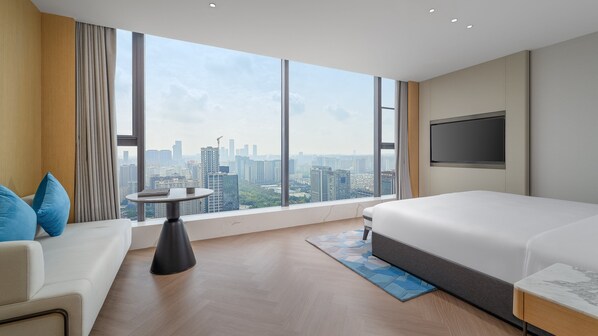 A hotel room with a large window, a bed, a TV, a small table, and a sofa. - Even Hotel Xi An High Tech Zone By Ihg (Xi'an)