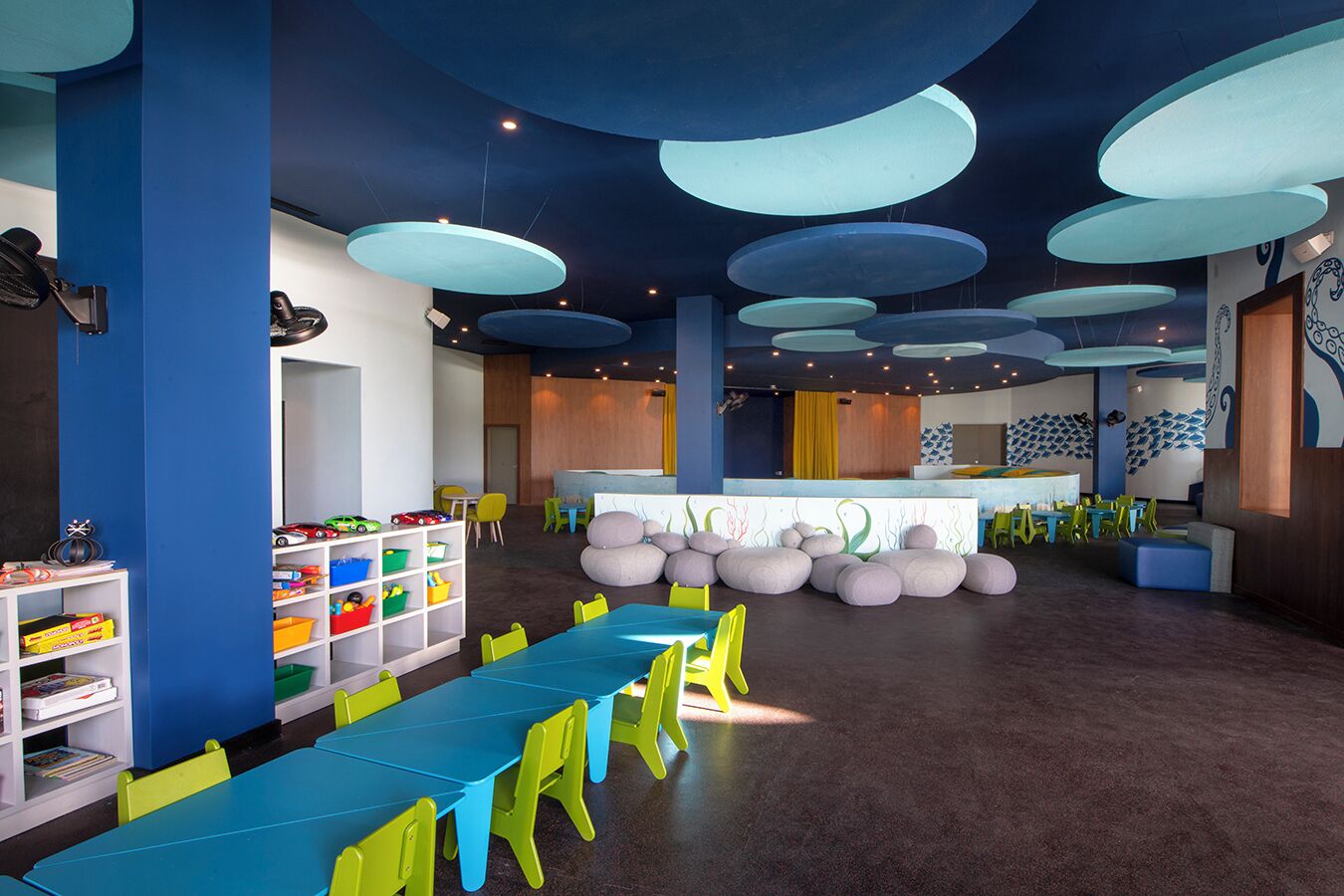 A children's play area with colorful furniture and storage units.
