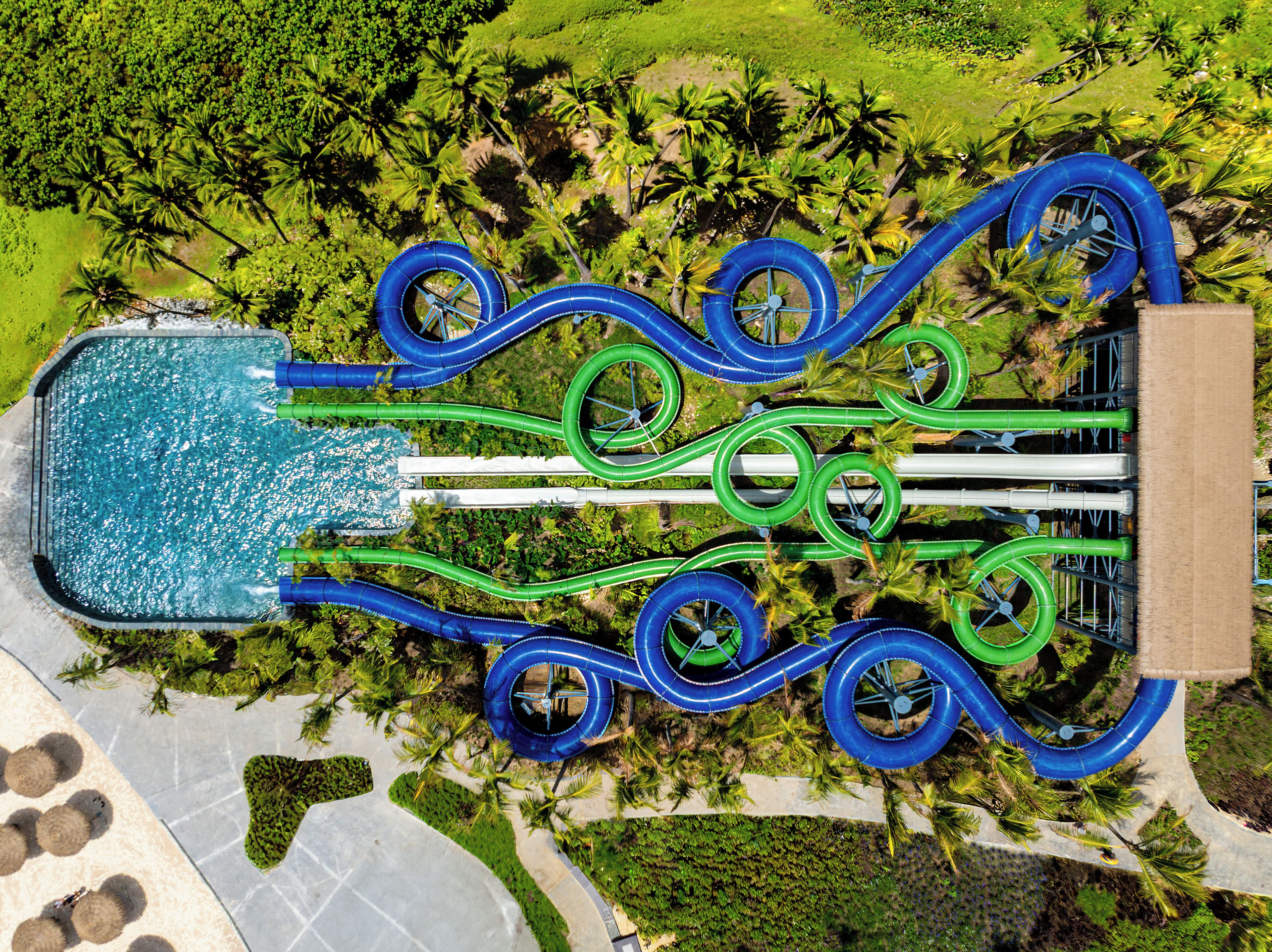 An aerial view of a water park with multiple slides and a central pool.