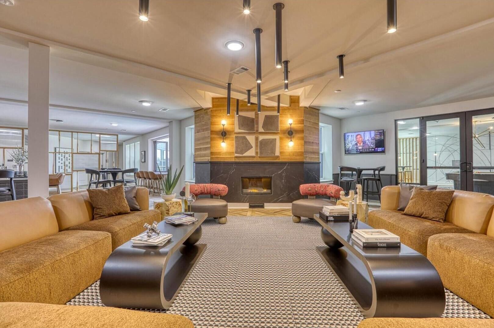A spacious living area with two sofas, a coffee table, and a fireplace.