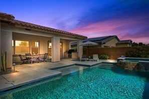 A swimming pool area with a patio, outdoor furniture, and a sunset sky. - 3-bedroom house with private pool and hot tub in beautiful Palm Desert (Palm Desert)