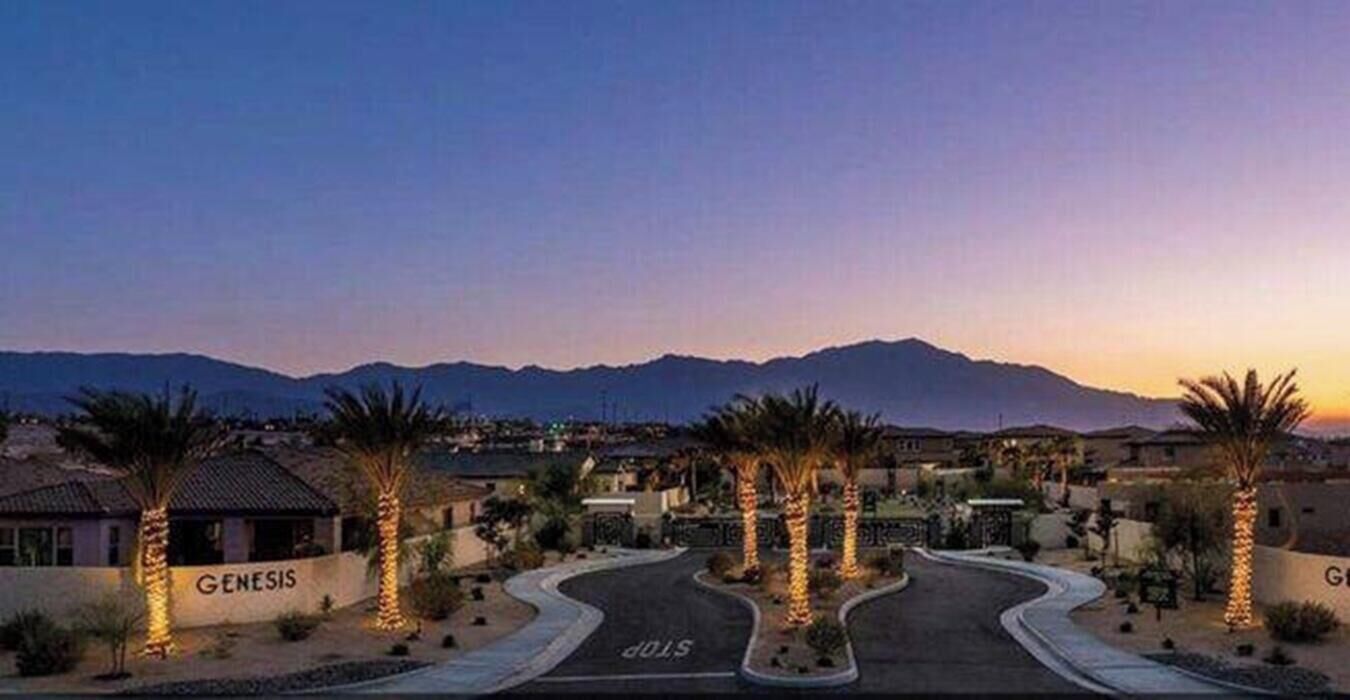 A residential area with a curved road, palm trees, and houses labeled "GENESIS."