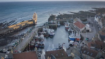 A coastal town with a harbor, boats, and buildings.