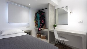 Ein modernes Schlafzimmer mit Bett, Schreibtisch, Stuhl, Kleiderschrank und Spiegel.