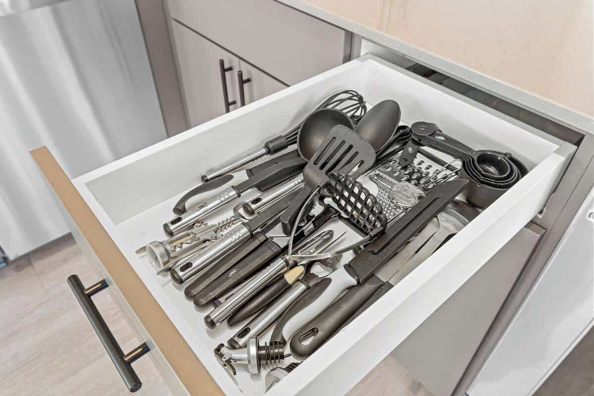 A drawer filled with various kitchen utensils.