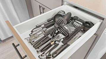 A drawer filled with various kitchen utensils.