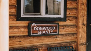 Puuinen mökki, jonka kyltissä lukee: ”Dogwood Shanty”.
