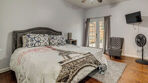 A bedroom with a bed, a ceiling fan, a TV, and a window with curtains. - Sip, Hike & Explore: Quiet SoCal Studio w/ Patio! (Winchester)