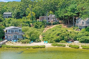 A lakeside property with multiple houses, a dock, and a sandy beach area. - Steps to Beach: Martha's Vineyard Private Retreat! (Vineyard Haven)