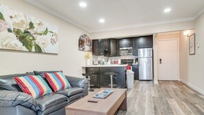 A modern kitchen with dark cabinets, stainless steel appliances, and a wooden countertop. - Shop, Hike & Sip Wine: Pleasanton Gem w/ Balcony! (Pleasanton)